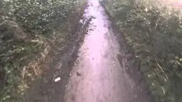 Riding down a muddy bumpy lane