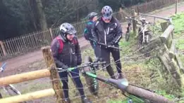 Three blokes trying to remove a fat bike from an electric fence