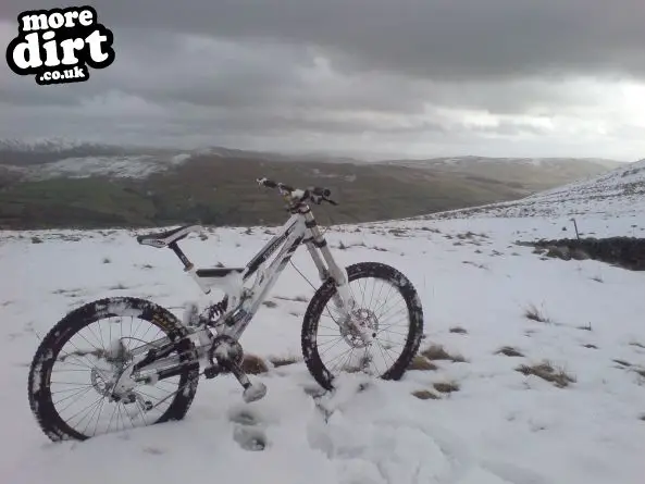 My bike covered in snow overlooking the lakes