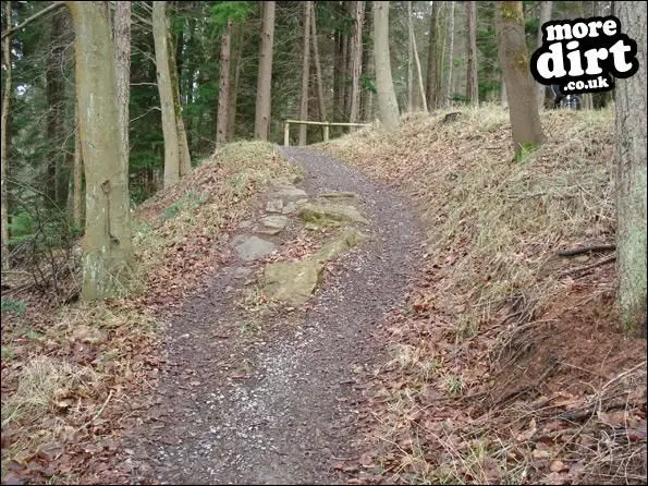 rocky obstacle on uphill section which winds back 