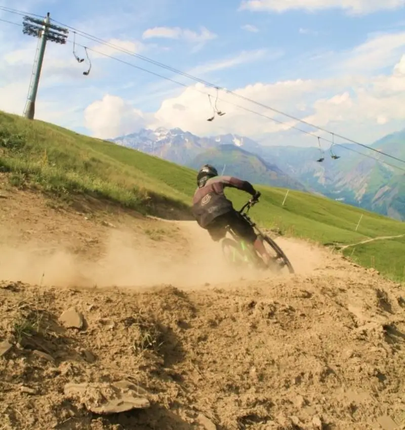 Railing a dusty berm in the alps