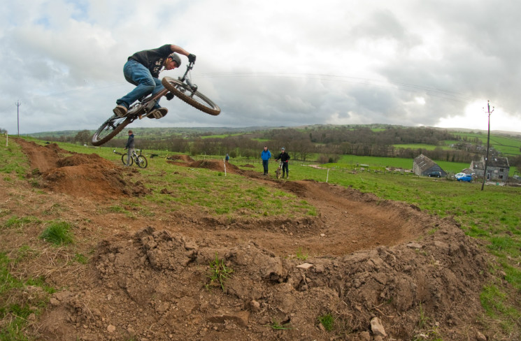 Mike sending his XC bike into a berm