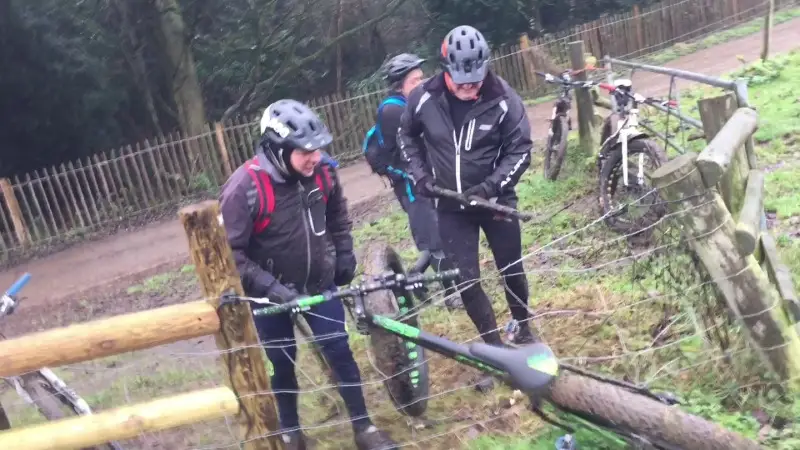 Three blokes trying to remove a fat bike from an e